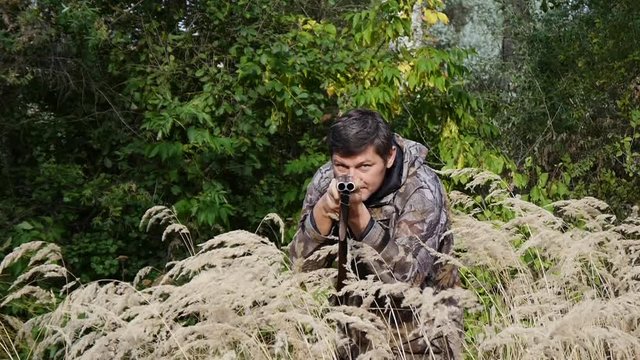 Hunter hiding in the tall grass and wild beast hunts