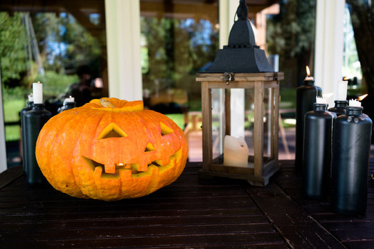preparation for Halloween - the pumpkin and candle on a wooden table