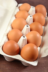 Carton of fresh brown eggs