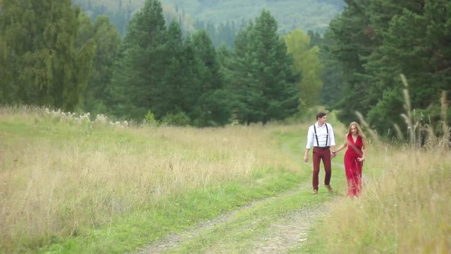 couple walking in the forest hand