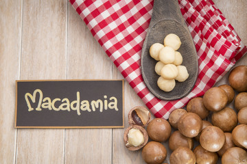 Nuts, macadamia nut on wooden background. From the top view