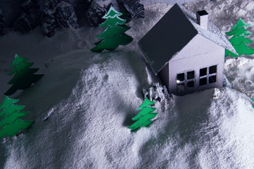 Handmade paper house and trees in winter