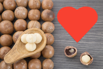 Nuts, macadamia nut on wooden background. From the top view