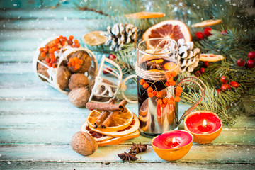 mulled wine with orange and spices on wooden background.Christmas decoration