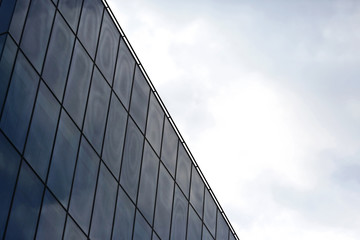 Fototapeta na wymiar glass facade of the building against the sky
