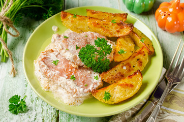 Pork chops with sour cream and baked potatoes