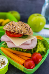 Tasty food in plastic lunch box on light background.
