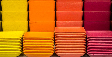 Pile of  colorful plastic plates and pots. They are for sale in Thailand.