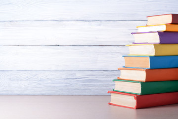 Stack of colorful books on table. Education background. Back to school. Copy space for text.