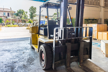 Front of old forklift vehicle used in industrial warehouse. It is also called lift or fork truck.