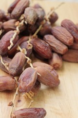 Dried date palm delicious on wood background.