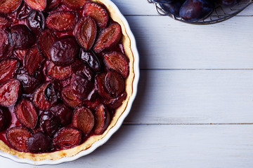 Homemade pie with plums on the table