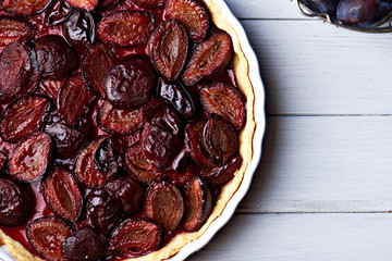 Homemade pie with plums on the table