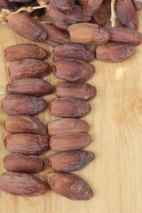 Dried date palm delicious on wood background.