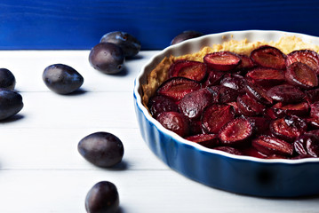 Homemade pie with plums on the table