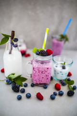 Delicious berry smoothies  made with fresh ingredients on light background.