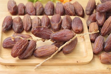 Dried date palm delicious on wood background.