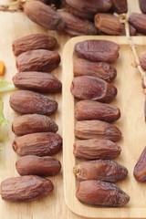 Dried date palm delicious on wood background.