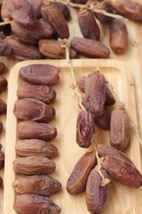 Dried date palm delicious on wood background.