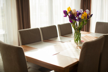 dining table with chairs in the dining room , a beautiful bouque