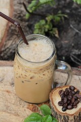 Iced coffee is delicious on wood background.