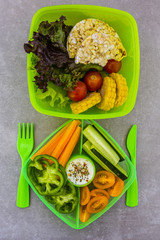 Healthy vegetarian food in plastic lunch box on light background.
