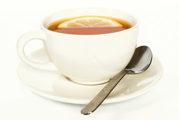 Cup of lemon tea with a spoon. Selective focus, white background.