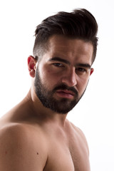 Closeup portrait of naked handsome hipster man with bear looking at camera isolated on white background in studio.