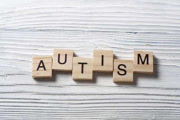 text of AUTISM on wood cubes. Wooden abc.