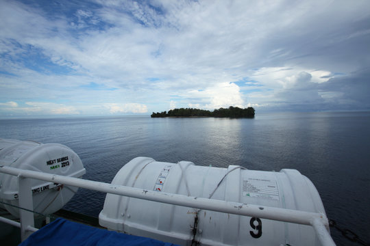 ferry to the island with blue ocean waters and sky