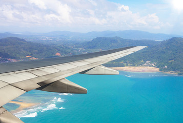 Airplane flying above beach sea blue in phuket island - Travel Concept