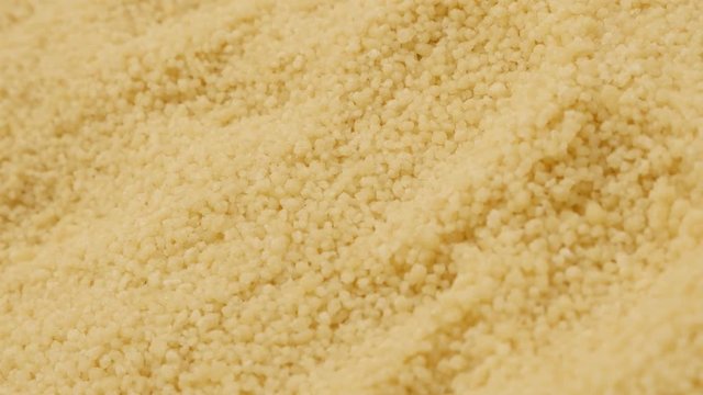 Panning over steamed balls of semolina traditional north African food 4K 2160p 30fps UltraHD video - Instant Couscous balls pile background close-up slow pan 3840X2160 UHD footage 
