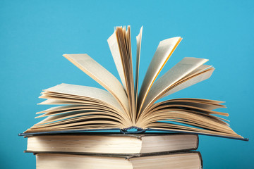 Open book, hardback books on wooden table. Education background. Back to school. Copy space for text.