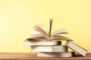 Fototapeta premium Open book, hardback books on wooden table. Education background. Back to school. Copy space for text.