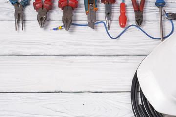 Set of electrical tool on wooden background. Accessories for engineering work, energy concept.
