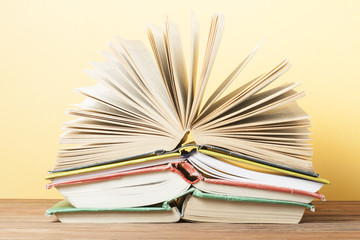 Open book, hardback books on wooden table. Education background. Back to school. Copy space for text.