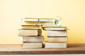 Open book, hardback books on wooden table. Education background. Back to school. Copy space for text.