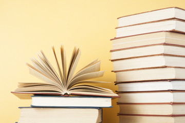 Open book, hardback books on wooden table. Education background. Back to school. Copy space for text.