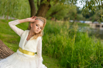 Fototapeta na wymiar Fashion photo of a young girl in a beautiful white dress