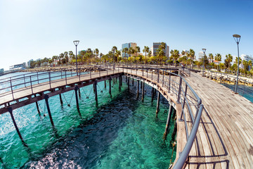 Fototapeta na wymiar View of Molos Promenade from the wooden pier on the coast of Lim