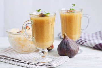 A delicious fresh melon and fig smoothie in a glass with a slice