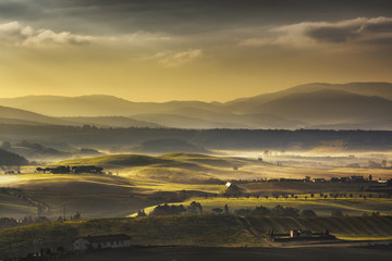 Tuscany Maremma foggy morning, farmlands and green fields. Italy
