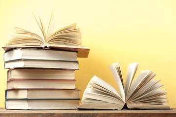 Open book, hardback books on wooden table. Education background. Back to school. Copy space for text.