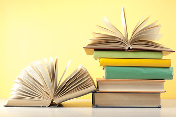 Open book, hardback books on wooden table. Education background. Back to school. Copy space for text.