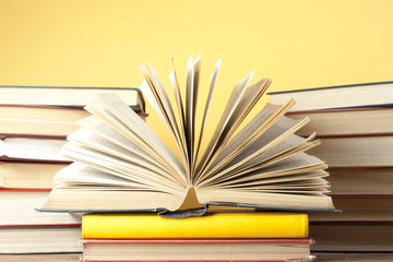 Open book, hardback books on wooden table. Education background. Back to school. Copy space for text.