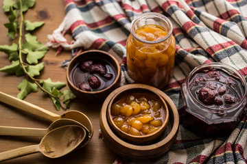 Strawberry and Yellow Cherry Jam with a Rustic Tablecloth.
