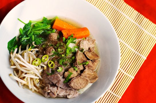 Delicious spicy rice noodle soup with pork and vegetables,original thai's fast food.