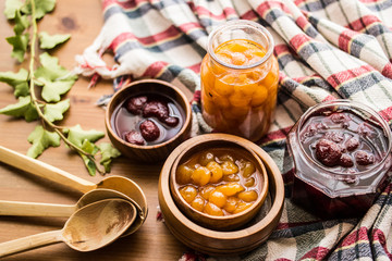 Strawberry and Yellow Cherry Jam with a Rustic Tablecloth.