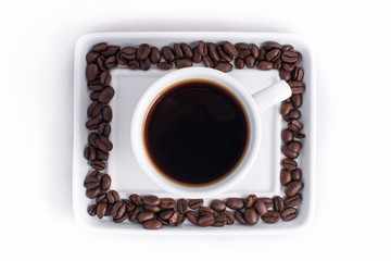 Cup of coffee arranged with fresh roasted coffee beans