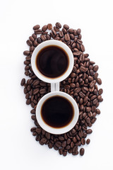 Cup of coffee arranged with fresh roasted coffee beans